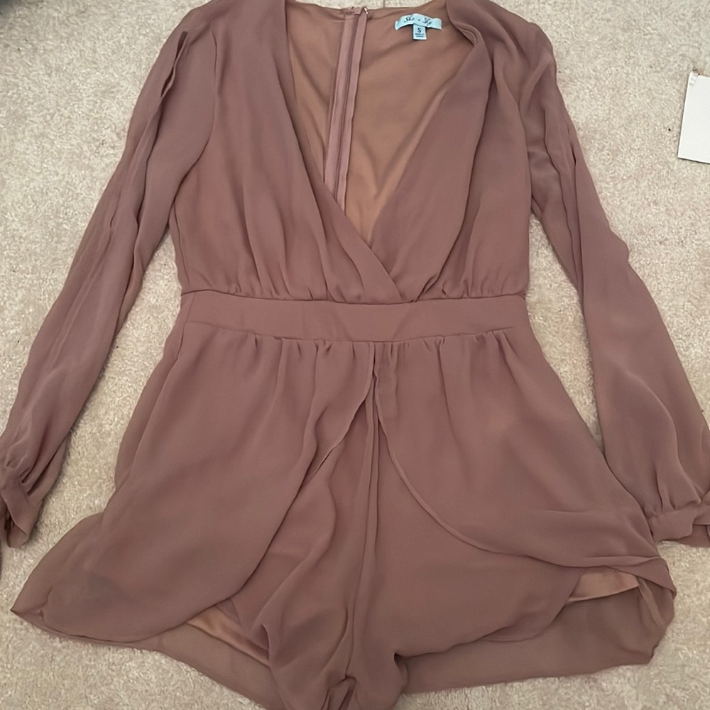 dark purple-ish romper, slits in the arms, low v neck.